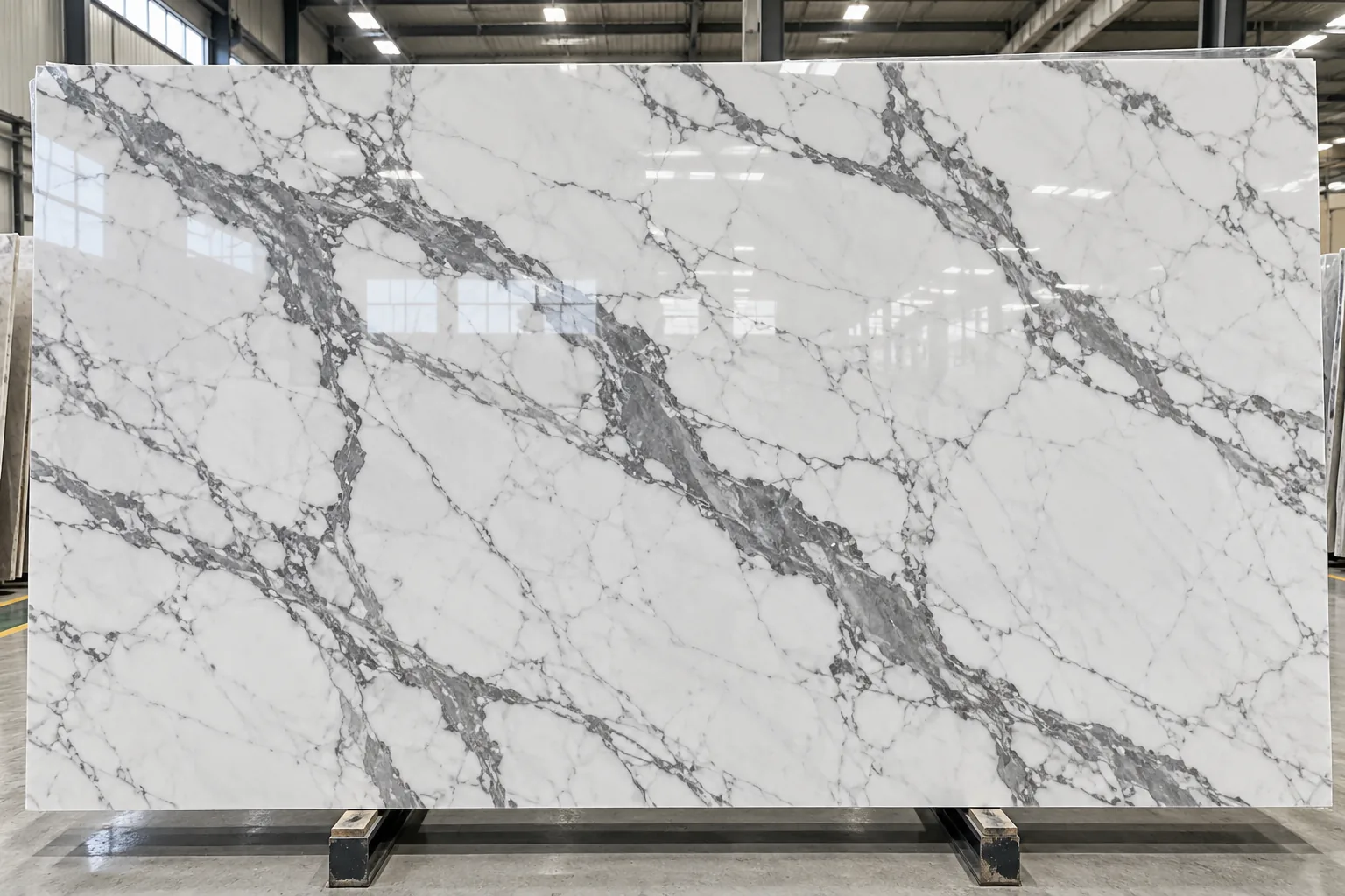 Polished Statuario Venato marble slab with bold grey veining